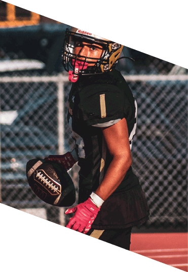A young man wearing a football uniform is smiling and laughing. AI generated content