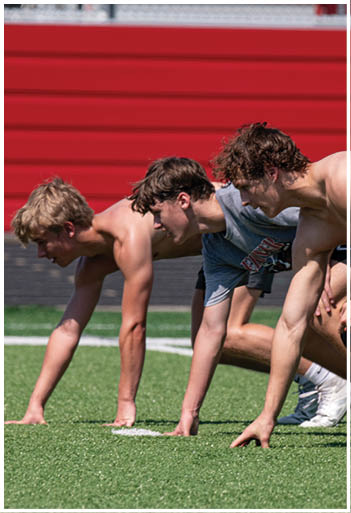 A football player running on the field. Description generated by AI