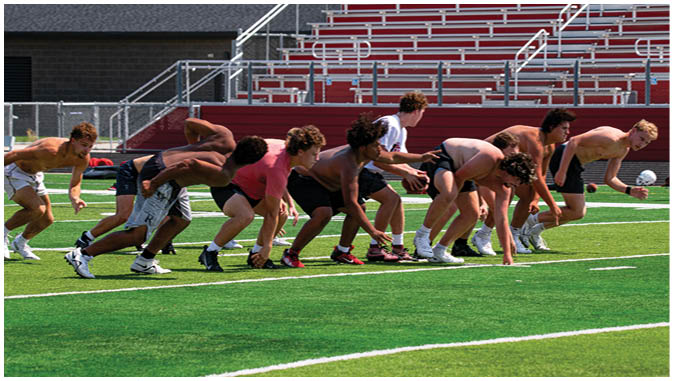 A group of football players on a field. Description generated by AI