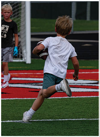 A football player wearing a blue jersey with the number 58 on it. Description generated by AI