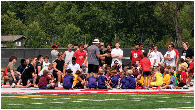 A group of football players on a field. Description generated by AI