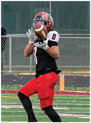 A football player wearing a blue jersey with the number 58 on it. Description generated by AI