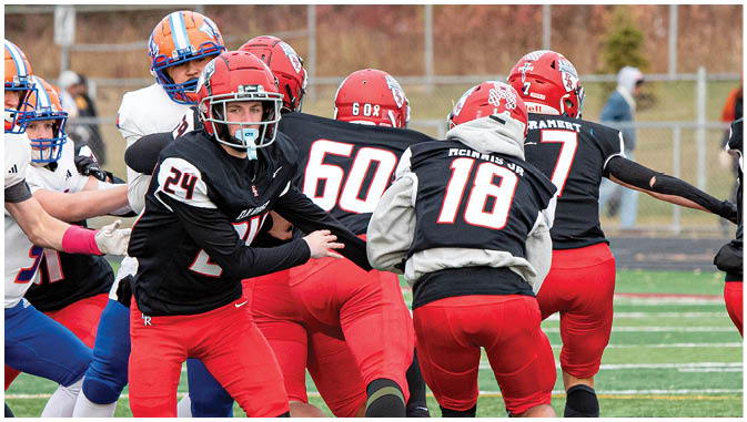 A group of football players on a field. Description generated by AI