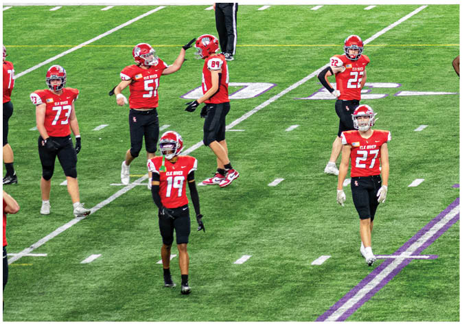 A group of football players wearing black and white uniforms. Description generated by AI