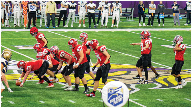 A group of football players on a field. Description generated by AI