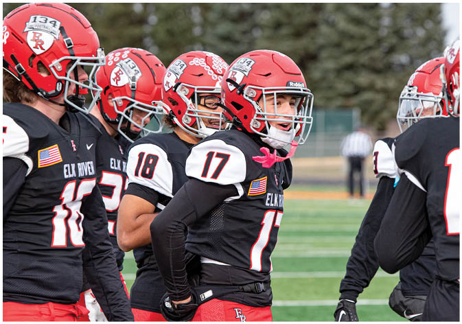 A group of football players wearing black and white uniforms. Description generated by AI