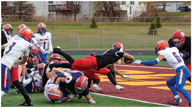 A group of football players on a field. Description generated by AI