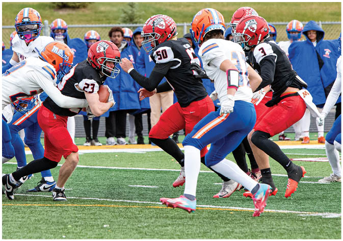 A group of football players wearing black and white uniforms. Description generated by AI