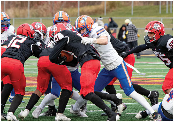 A group of football players wearing black and white uniforms. Description generated by AI