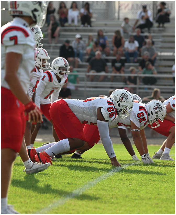 A group of football players on a field. Description generated by AI