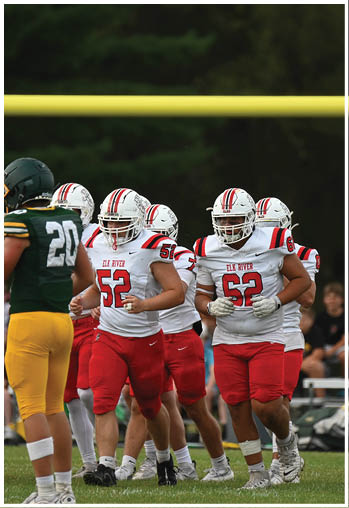 A group of football players celebrating a touchdown. Description generated by AI