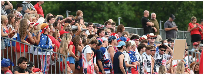 A football game is taking place on a field with players wearing blue and white uniforms. Description generated by AI
