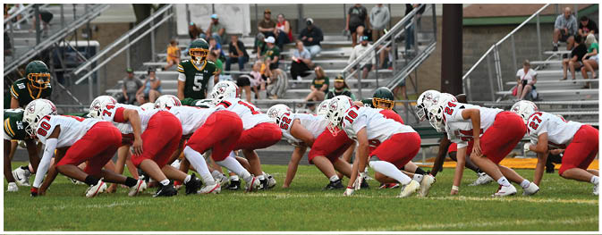 A group of football players on a field. Description generated by AI
