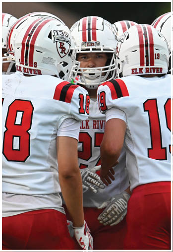 A group of football players celebrating a touchdown. Description generated by AI