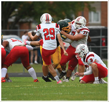 A group of football players celebrating a touchdown. Description generated by AI