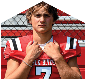 A young man wearing a white jersey with the number 10 on it. Description generated by AI