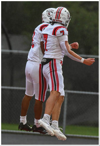 A group of football players celebrating a touchdown. Description generated by AI