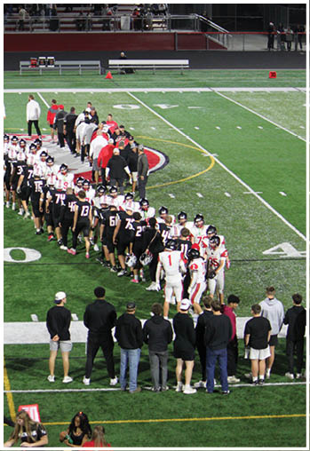 A group of football players celebrating a touchdown. Description generated by AI