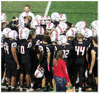 A group of football players celebrating a touchdown. Description generated by AI