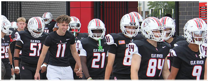 A group of football players on a field. Description generated by AI