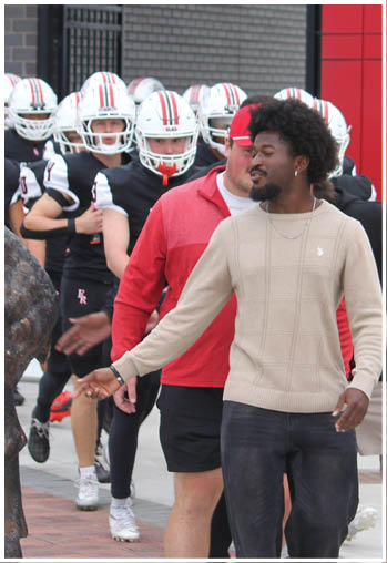 A group of football players celebrating a touchdown. Description generated by AI