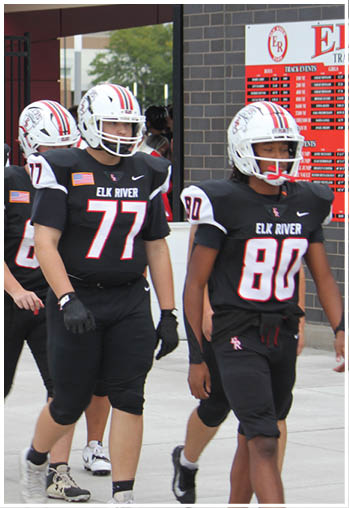 A group of football players celebrating a touchdown. Description generated by AI