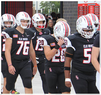 A group of football players celebrating a touchdown. Description generated by AI