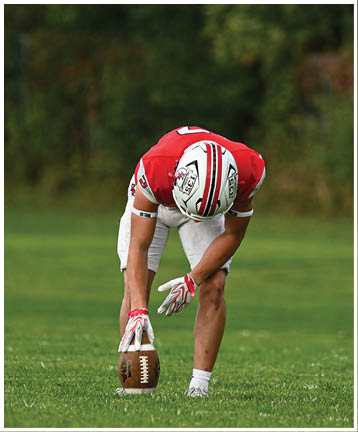A football player running on the field. Description generated by AI