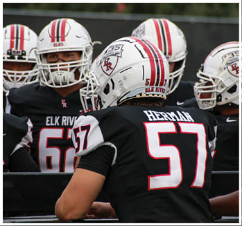 A group of football players celebrating a touchdown. Description generated by AI