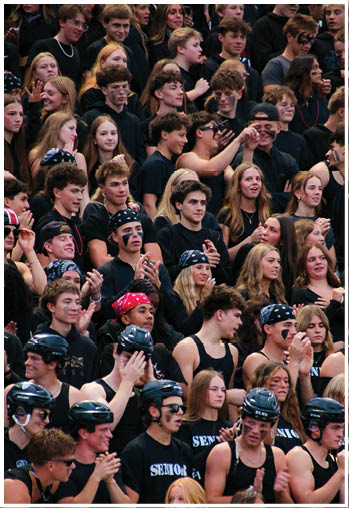A group of football players celebrating a touchdown. Description generated by AI