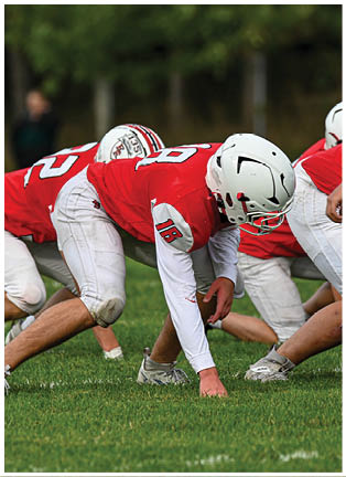 A football player running on the field. Description generated by AI