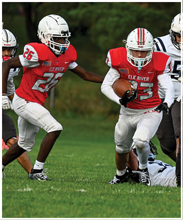 A football player running on the field. Description generated by AI