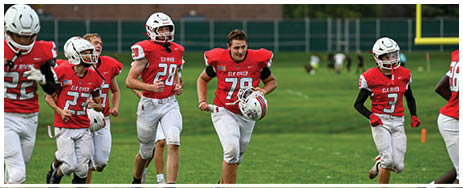 A football player running on the field. Description generated by AI