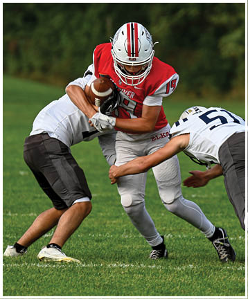 A football player running on the field. Description generated by AI