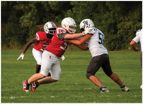 A football player running on the field. Description generated by AI