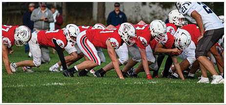 A football player running on the field. Description generated by AI