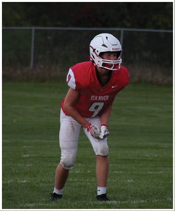 A football player running on the field. Description generated by AI