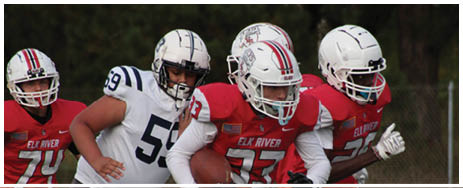 A football player running on the field. Description generated by AI