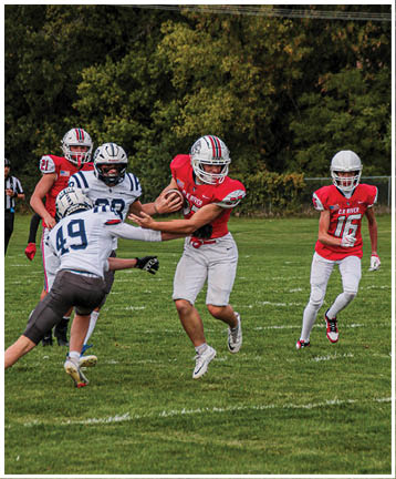 A football player running on the field. Description generated by AI