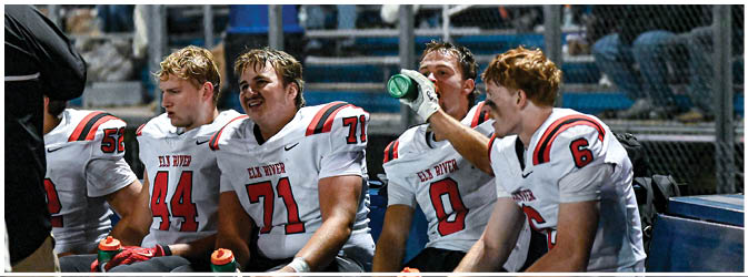 A football game is taking place on a field with players wearing blue and white uniforms. Description generated by AI