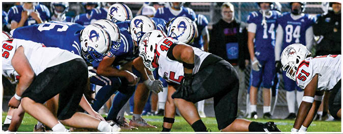 A group of football players on a field. Description generated by AI