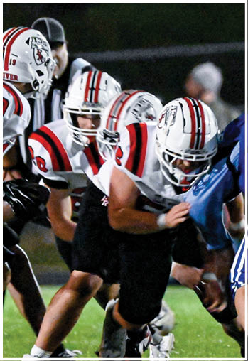 A group of football players celebrating a touchdown. Description generated by AI