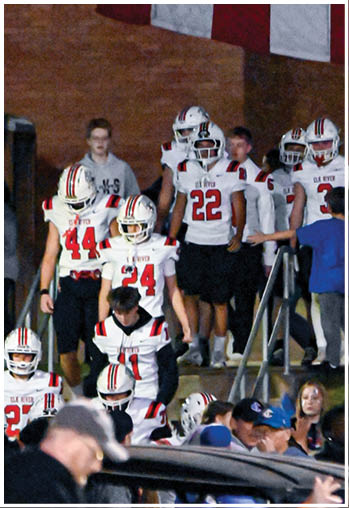 A group of football players celebrating a touchdown. Description generated by AI