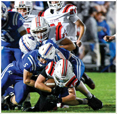 A football game is taking place with a group of men on the field. Description generated by AI