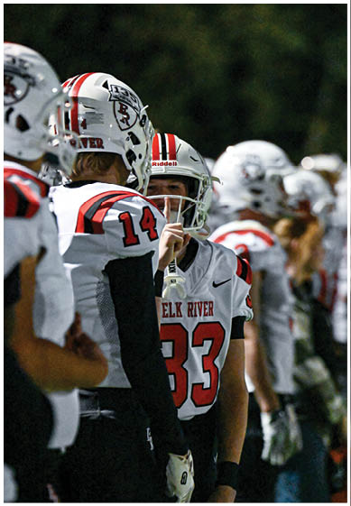 A football player wearing a blue and red jersey. Description generated by AI