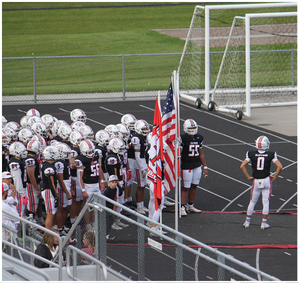 A group of football players on a field. Description generated by AI