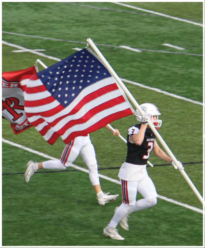 A group of football players celebrating a touchdown. Description generated by AI