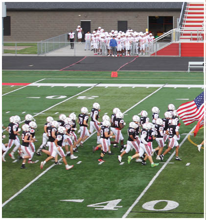 A group of football players celebrating a touchdown. Description generated by AI
