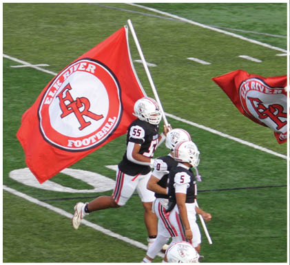 A group of football players celebrating a touchdown. Description generated by AI