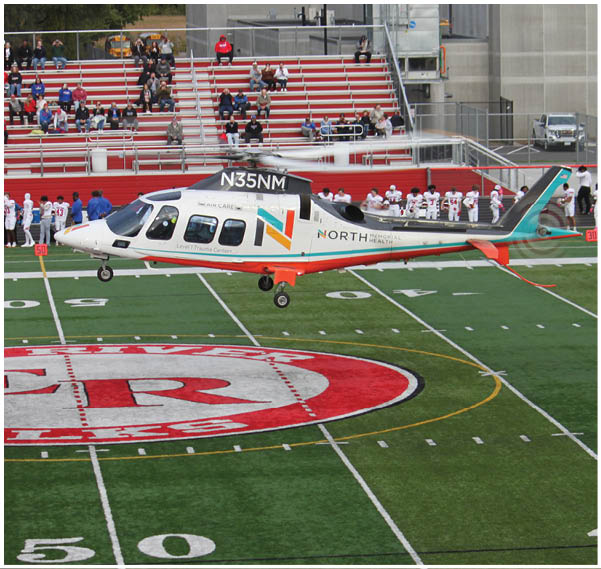 A group of football players on a field. Description generated by AI
